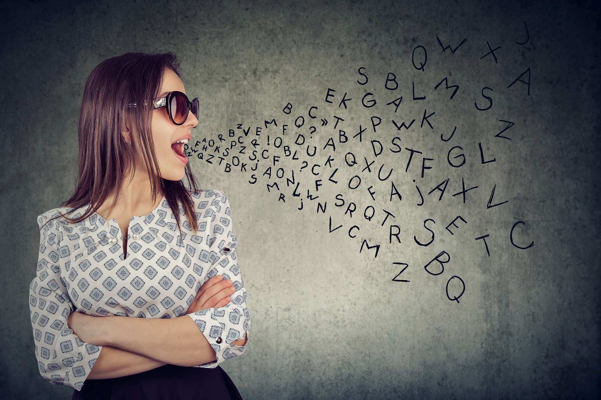 Woman In Sunglasses Talking With Alphabet Letters Coming Out Of Her Mouth.